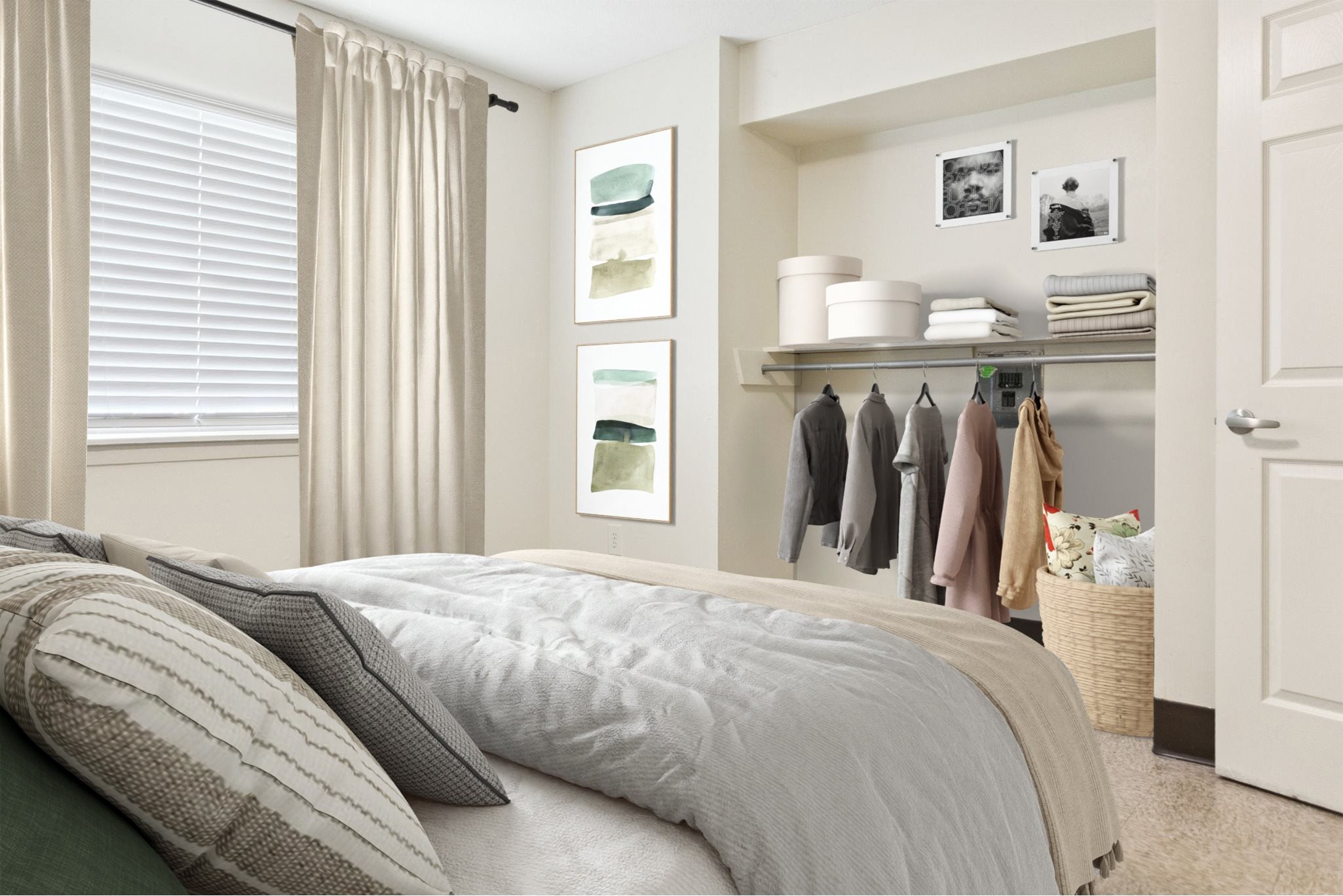 A bedroom with a bed, pillows, a shelf with clothes and towels, and pictures on the wall.